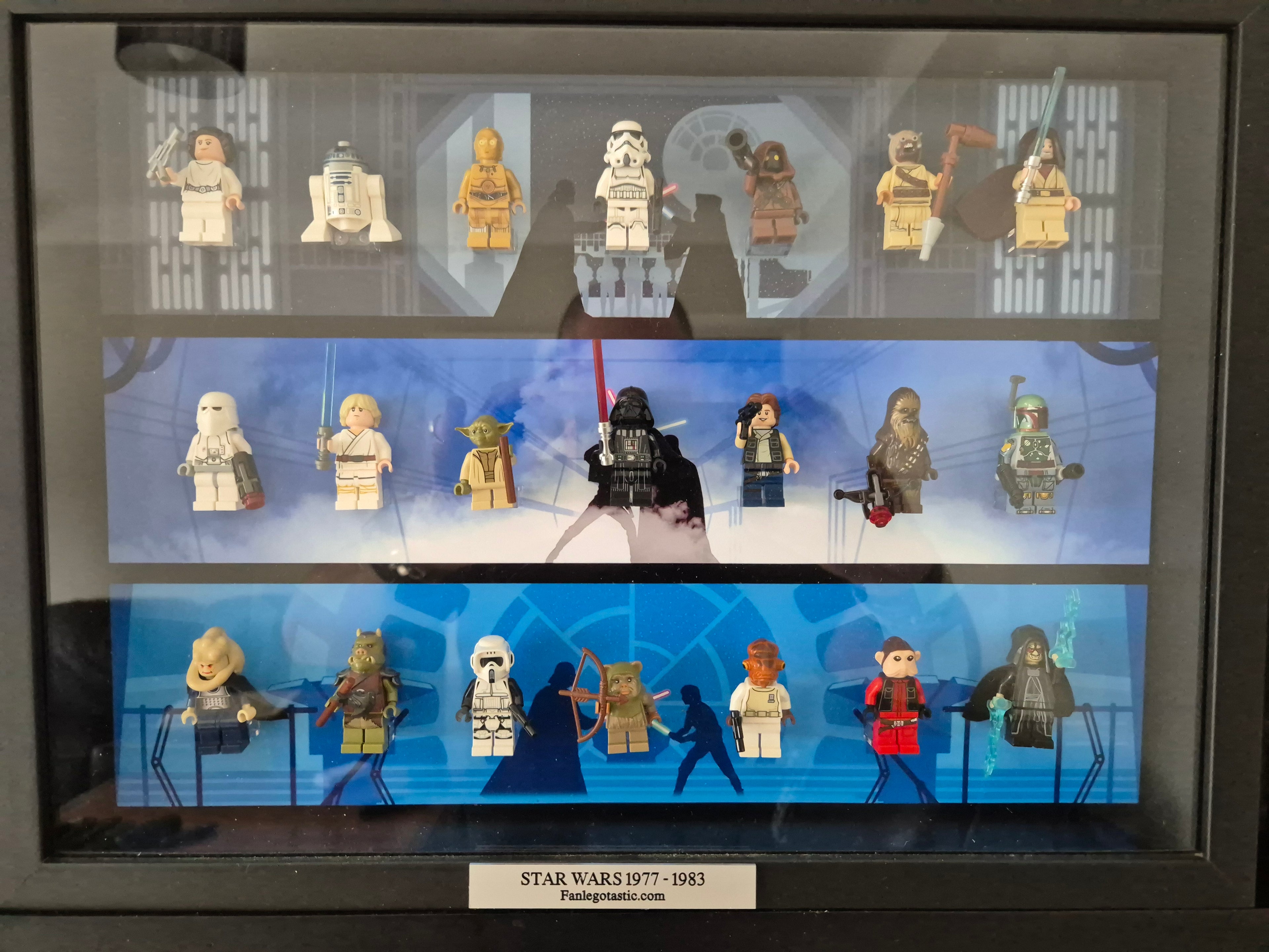 Collection of Star Wars mini figures displayed in a framed case with a blue background.